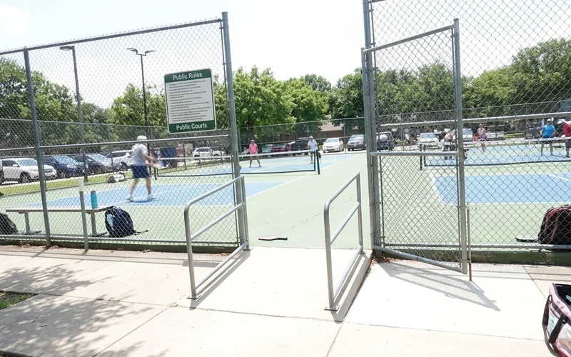 Accessible approach ramp and wide gate entry onto a public sport court