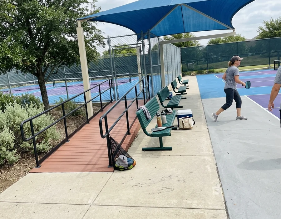 Completed HOA amenity courts with accessible entry and shade seating