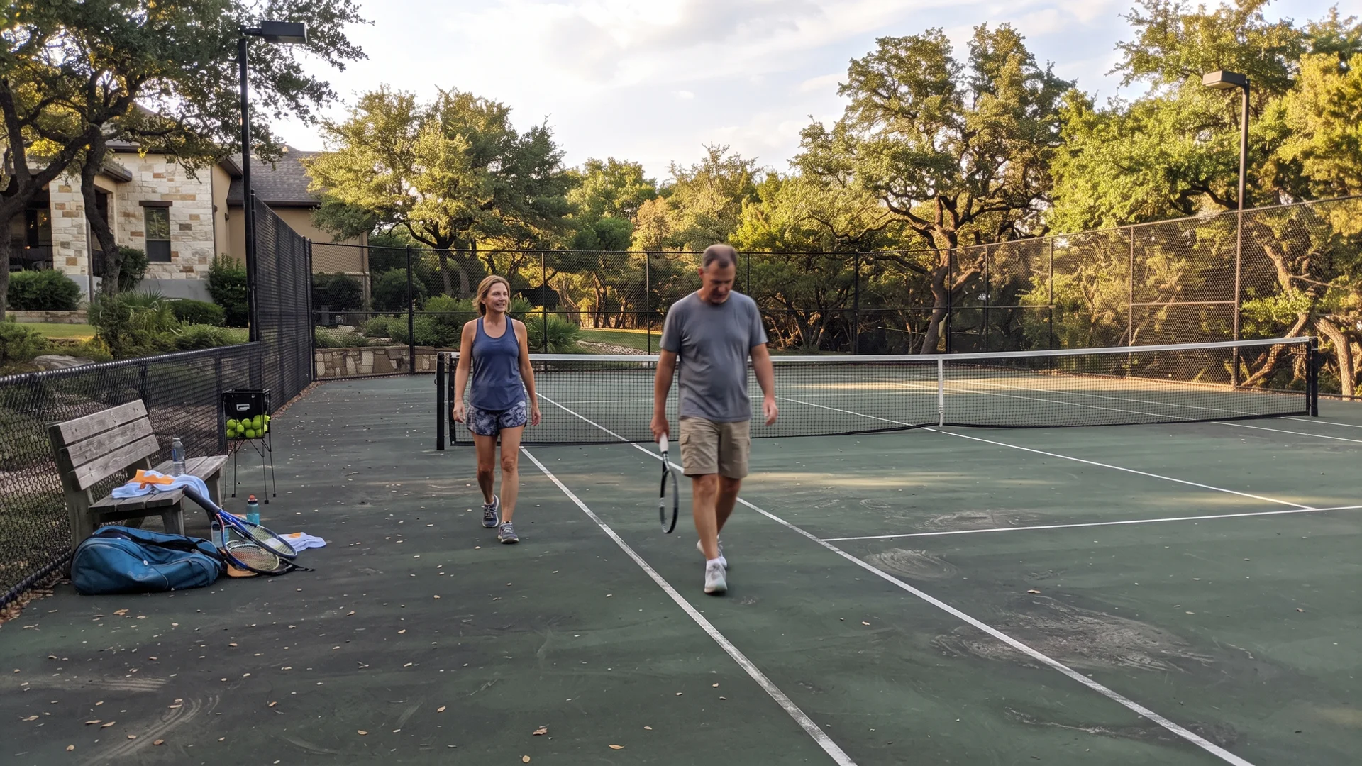 Finished residential tennis court with fencing on a North Texas estate lot