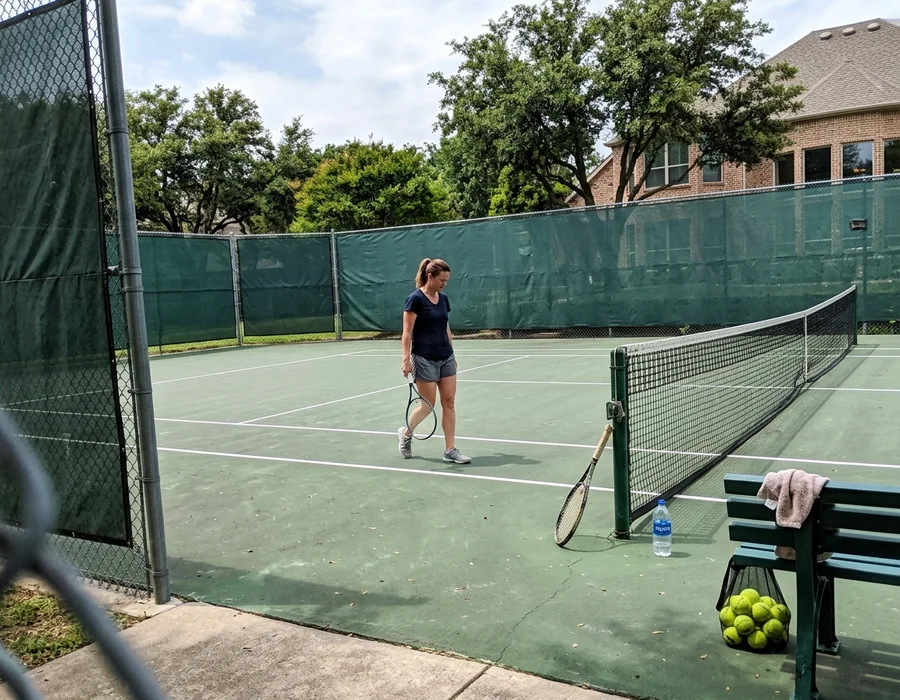 Residential tennis court with windscreens in Colleyville, TX
